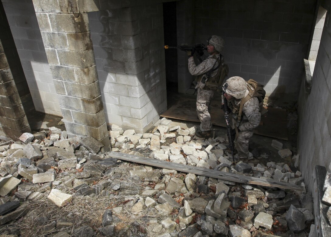 U.S. Marines with Fox Company, Battalion Landing Team 2/6, 26th Marine Expeditionary Force, provide cover fire as an assault team prepares to enter a building during military operations in urban terrain (MOUT) training at Fort Pickett, Va., April 11, 2015. The 26th MEU is conducting realistic urban training in preparation for deployment in the 5th and 6th Fleet areas of responsibility later this year. (U.S. Marine Corps Photo by Staff Sgt. Bobby J. Yarbrough/Released)