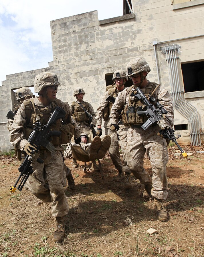 U.S. Marines with Fox Company, Battalion Landing Team 2/6, 26th Marine Expeditionary Force, carry a simulated casualty to an aerial landing zone during a realistic urban training exercise at Fort Pickett, Va., April 11, 2015. The 26th MEU is conducting realistic urban training in preparation for deployment in the 5th and 6th Fleet areas of responsibility later this year. (U.S. Marine Corps Photo by Staff Sgt. Bobby J. Yarbrough/Released)