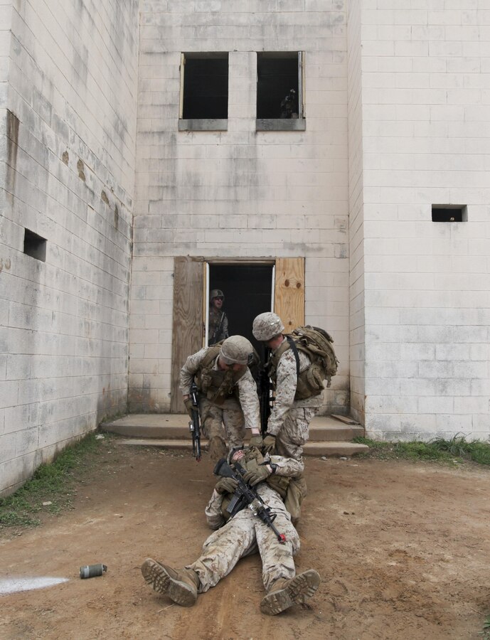 U.S. Marines with Fox Company, Battalion Landing Team 2/6, 26th Marine Expeditionary Force, drag a simulated casualty into a building during military operations in urban terrain (MOUT) training at Fort Pickett, Va., April 11, 2015. The 26th MEU is conducting realistic urban training in preparation for deployment in the 5th and 6th Fleet areas of responsibility later this year. (U.S. Marine Corps Photo by Staff Sgt. Bobby J. Yarbrough/Released)