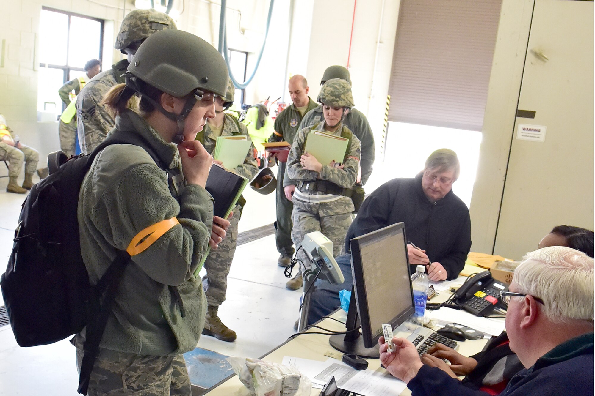 Air Force Reserve Senior Airman Rachel Kocin processes through the deployment line during the Operation Patriot Penguin mobilization exercise here April 11, 2015. Kocin is a photojournalist for the 910th Airlift Wing Public Affairs Office.  (U.S. Air Force photo/Tech. Sgt. James Brock)