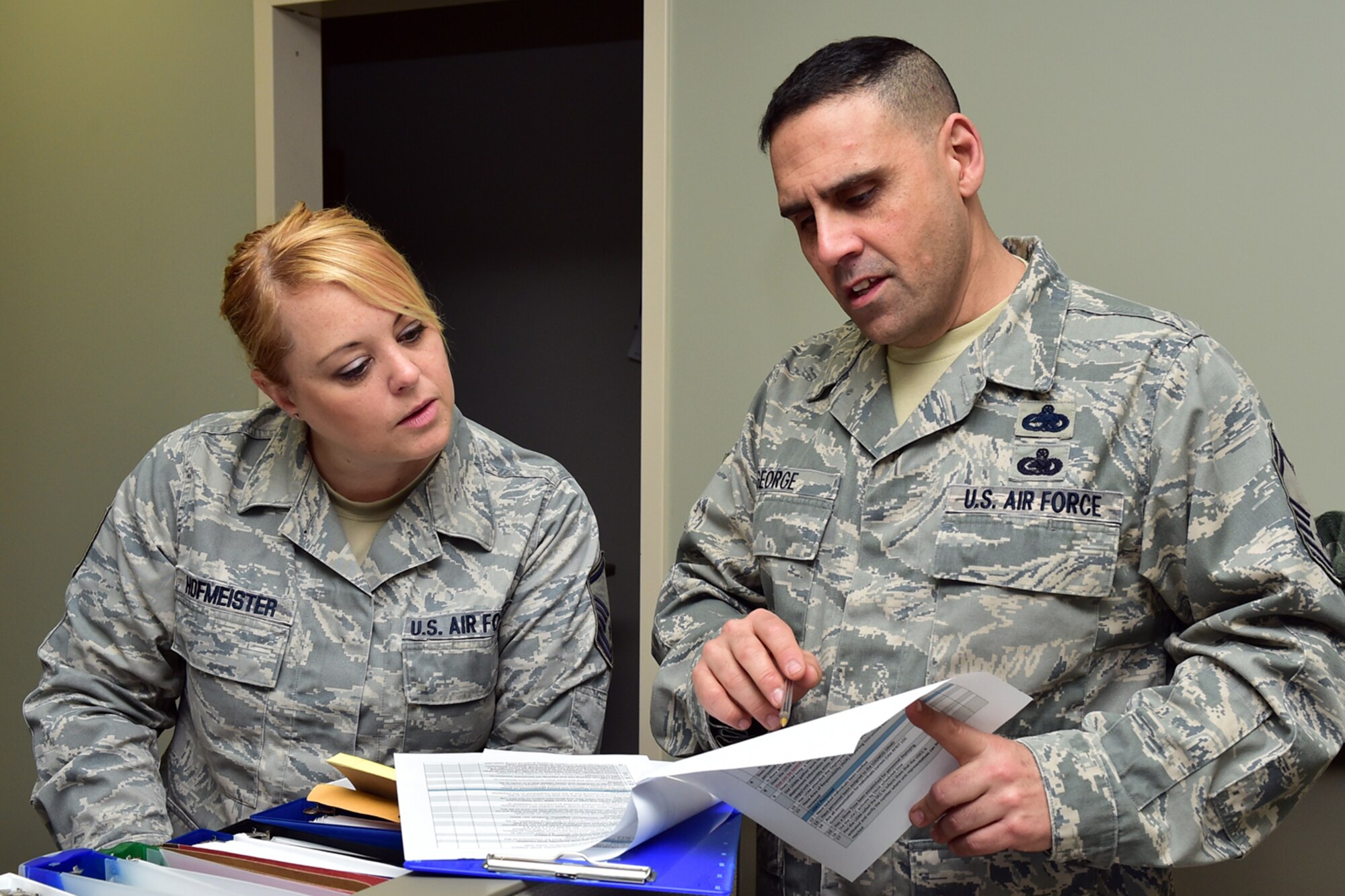 Air Force Reserve Senior Master Sgt. Robert George (right) reviews a requirements check list with Master Sgt. Sarah Hofmeister during the Patriot Penguin Mobilization Deployment exercise her April 11, 2015. George is Chief of War Plans and Mobilization for the 910th Logistics Readiness Squadron and Hofmeister is the 910th Airlift Wing Staff Unit Deployment Manager (UDM) for Airlift Wing staff. (U.S. Air Force photo/Tech. Sgt. James Brock)
