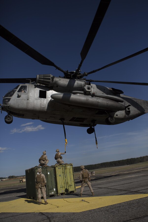 U.S. Marines with Combat Logistics Battalion 26, 26th Marine Expeditionary Unit (26th MEU), attach quadcon containers to a CH-53E Super Stallion with Marine Medium Tiltrotor Squadron (VMM) 162 (Reinforced), 26th MEU, during helicopter support training at Fort Pickett, Va., April 11, 2015. The long distance transportation of supplies by air can be used to support troops ashore such as when conducting a humanitarian assistance or disaster relief mission where supplies are needed in a timely manner. The 26th MEU is conducting realistic urban training in preparation for deployment in the 5th and 6th fleet area of responsibility later this year. (U.S. Marine Corps Photo by Cpl. Jeraco Jenkins/ 26th Marine Expeditionary Unit Combat Camera/Released)