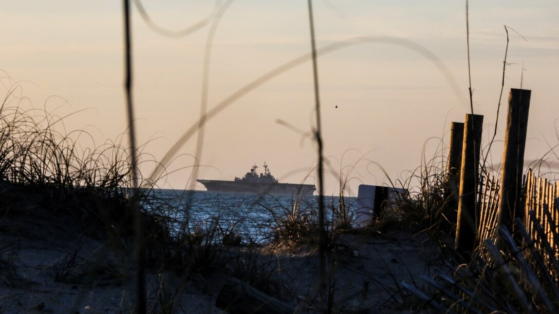 The multipurpose amphibious assault ship USS Kearsarge (LHD-3) waits off the coast of Camp Lejeune, N.C., to embark a platoon from Alpha Company, 2nd Assault Amphibian Battalion into its well-deck April 12, 2015. The platoon used amphibious assault vehicles to transport Marines from 1st Battalion, 6th Marine Regiment in support of a ship-to-shore exercise.