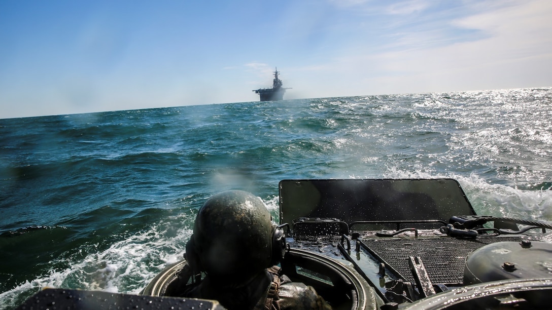 A Marine with 3rd Platoon, Alpha Company, 2nd Assault Amphibian Battalion drives an amphibious assault vehicle to the multipurpose amphibious assault ship USS Kearsarge (LHD-3) off the coast of Camp Lejeune, N.C., April 12, 2015. The platoon used amphibious assault vehicles to transport Marines from 1st Battalion, 6th Marine Regiment in support of a ship-to-shore exercise off the coast Onslow Beach. 