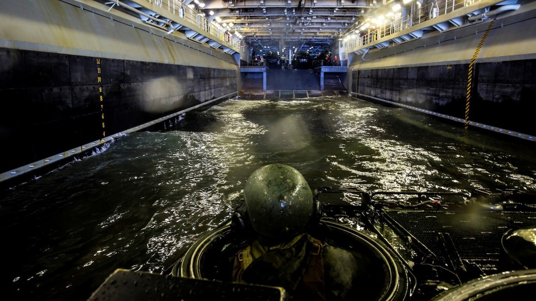 A Marine with 3rd Platoon, Alpha Company, 2nd Assault Amphibian Battalion enters the well-deck of the multipurpose amphibious assault ship USS Kearsarge (LHD-3) April 12, 2015. The platoon used amphibious assault vehicles to transport Marines from 1st Battalion, 6th Marine Regiment in support of a ship-to-shore exercise off the coast of Onslow Beach, Camp Lejeune, N.C. 