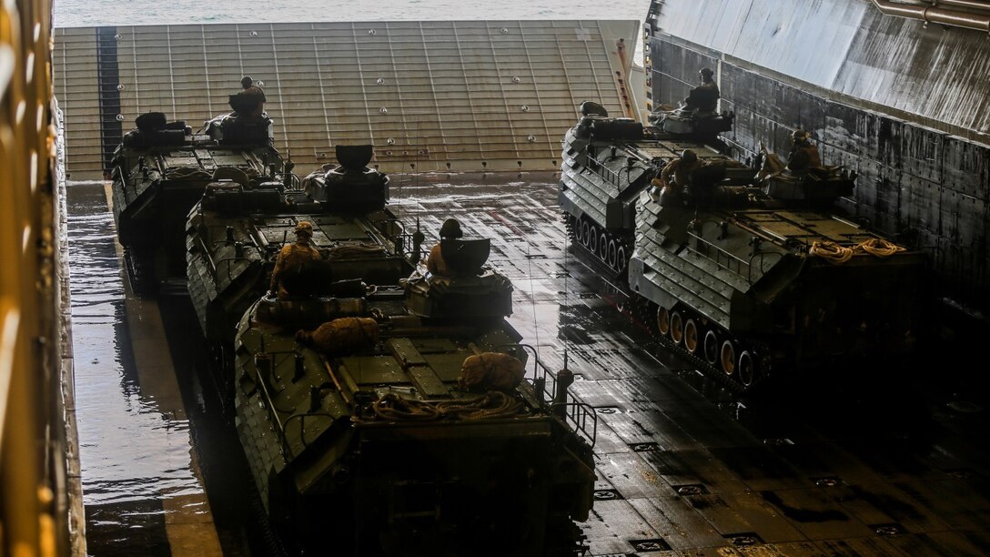 Marines with 3rd Platoon, Alpha Company, 2nd Assault Amphibian Battalion prepare to leave the well-deck of the multipurpose amphibious assault ship USS Kearsarge (LHD-3) April 13, 2015. The platoon used amphibious assault vehicles to transport Marines from 1st Battalion, 6th Marine Regiment in support of a ship-to-shore exercise off the coast of Onslow Beach, Camp Lejeune, N.C. 