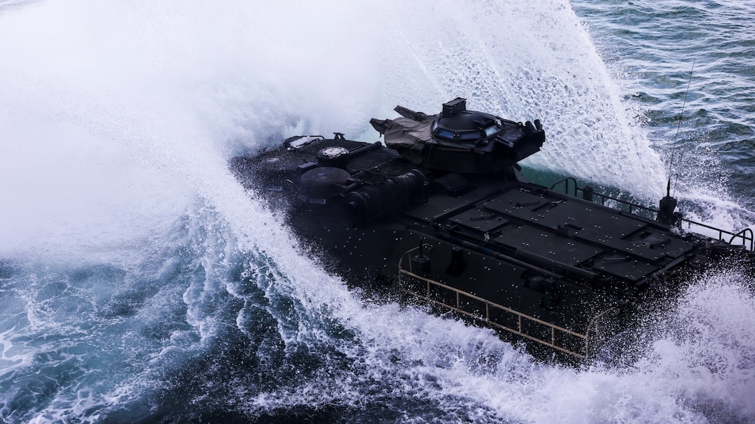 An amphibious assault vehicle belonging to 3rd Platoon, Alpha Company, 2nd Assault Amphibian Battalion splashes into the Atlantic Ocean from the well-deck of the multipurpose amphibious assault ship USS Kearsarge (LHD-3) April 13, 2015. The platoon used their amphibious assault vehicles to transport Marines from 1st Battalion, 6th Marine Regiment in support of a ship-to-shore exercise off the coast of Onslow Beach, Camp Lejeune, N.C. 