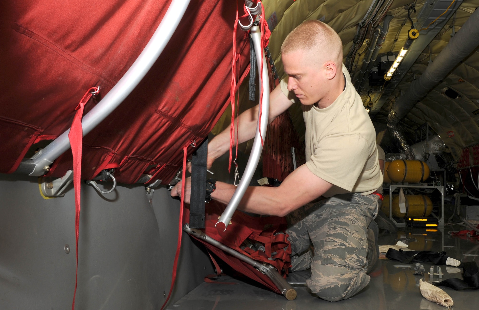 Senior Airman Robert Viera, a 22nd Maintenance Squadron aerospace maintenance journeyman, disassembles a damaged troop seat on a KC-135 Stratotanker during a periodic inspection, April 13, 2015, at McConnell Air Force Base, Kan. During the inspections, maintenance crews thoroughly examine the entire aircraft and make any necessary repairs. (U.S. Air Force photo/Airman 1st Class Tara Fadenrecht)