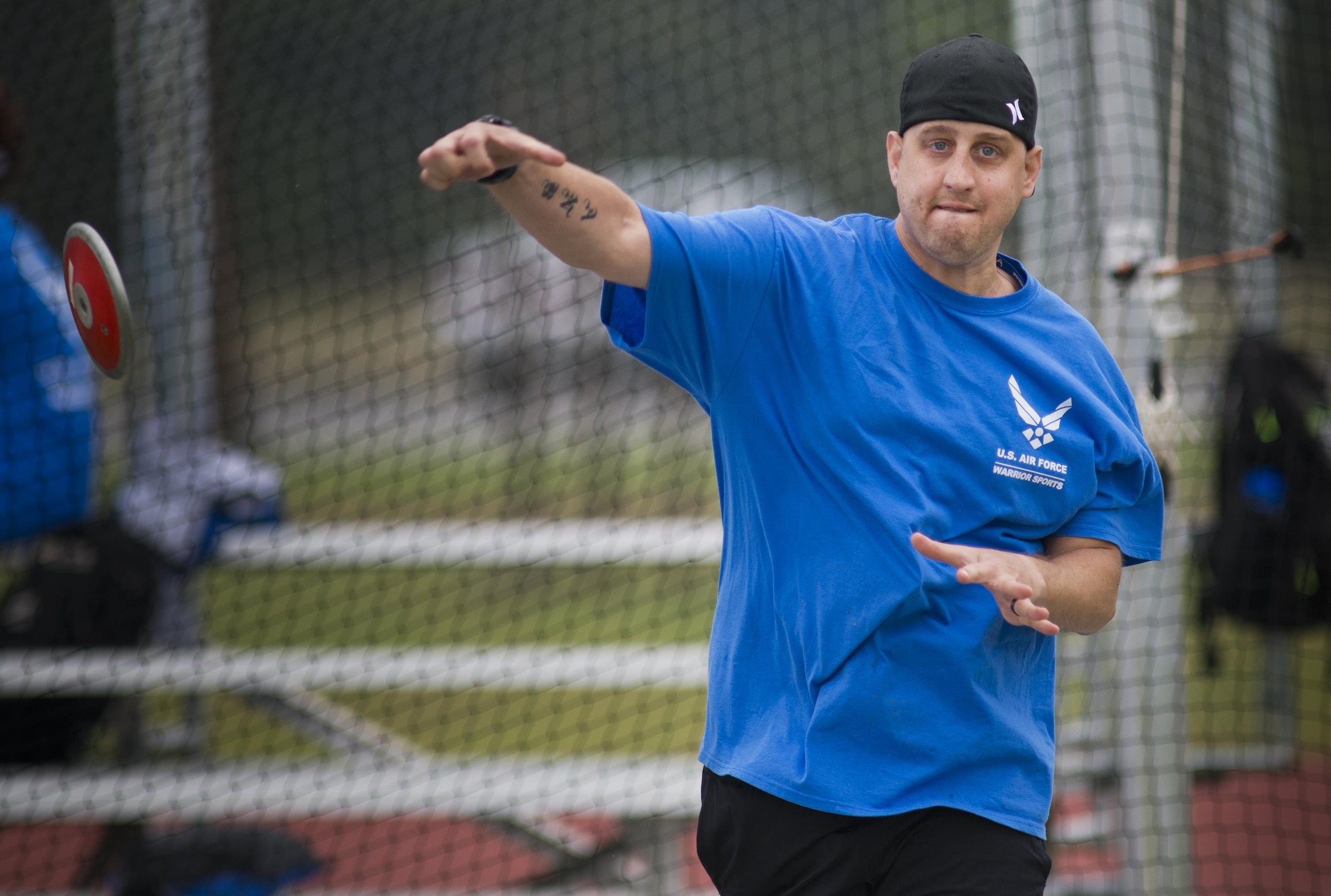 Senior Airman Chris Fugitt, a retired 96th Aircraft Maintenance Squadron Airman and an Air Force wounded warrior athlete, lets the discus fly at the track during the second day of an introductory adaptive sports and rehabilitation camp at Eglin Air Force Base, Fla., April 14, 2015. Two years after complications from a massive stroke forced Fugitt to retire from the Air Force, his warrior spirit enabled him to power past a number of debilitating setbacks and attend his first camp. (U.S. Air Force photo/Samuel King Jr.)