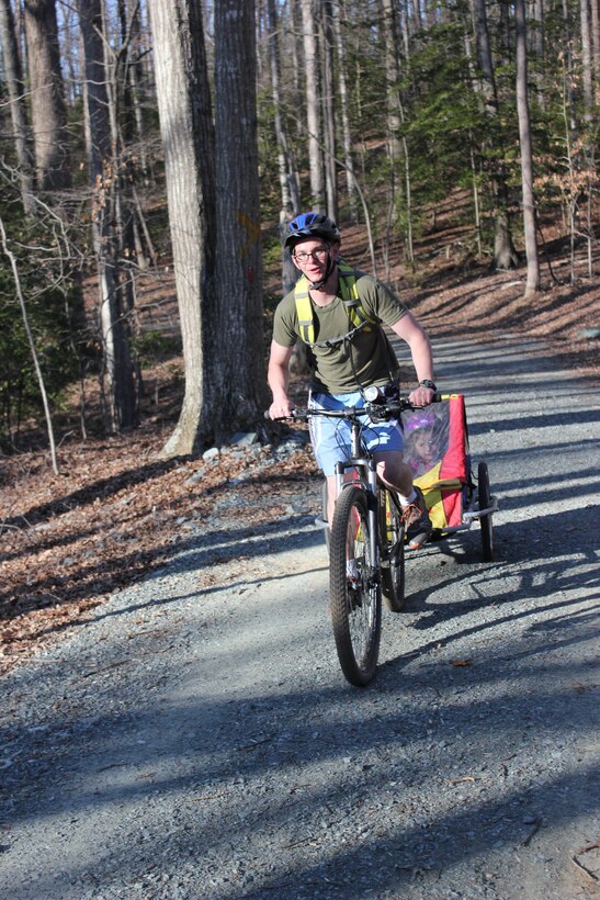 Sgt. Brian Murphy participates in a family fun ride with the Quantico Mountain Bike Club on April 1 while towing his daughters Alana, 4, and Eva, 3, behind him in a trailer.