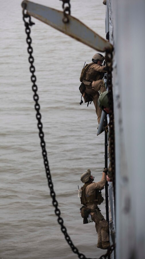 U.S. Marines assigned to Force Reconnaissance Platoon, Maritime Raid Force, 26th Marine Expeditionary Unit (MEU) board a ship during Visit, Board, Search, and Seizure (VBSS) training at Joint Base Langley-Eustis, Va., April 10, 2015. The exercise was part of the 26th MEU’s pre-deployment training, and allowed the Marines to enhance their skills in maritime operations. (U.S. Marine Corps photo by Lance Cpl. Andre Dakis/26th MEU Combat Camera/Released)