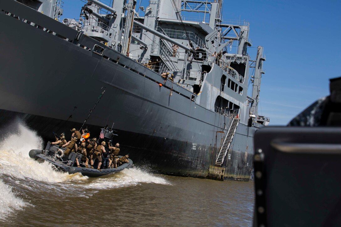 U.S. Marines assigned to Force Reconnaissance Platoon, Maritime Raid Force, 26th Marine Expeditionary Unit (MEU) prepare to board a ship from Rigid-Hull Inflatable Boats during Visit, Board, Search, and Seizure (VBSS) training at Joint Base Langley-Eustis, VA, April 12, 2015. The Marines were evaluated on their training as part of their preparation for deployment to the 5th and 6th Fleet Areas of responsibility later this year. (U.S. Marine Corps photo by Lance Cpl. Andre Dakis/26th MEU Combat Camera/Released)