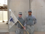 Sgt. Daniel Butts, left, an assistant convoy commander, and Sgt. Derick Woods, a convoy commander, both with the Louisiana National Guard's 199th Forward Support Company, 3rd Battalion, 156th Infantry Regiment, 3rd Sustainment Brigade, 103rd Sustainment Command (Expeditionary), pose for a photo before a recent overnight mission.