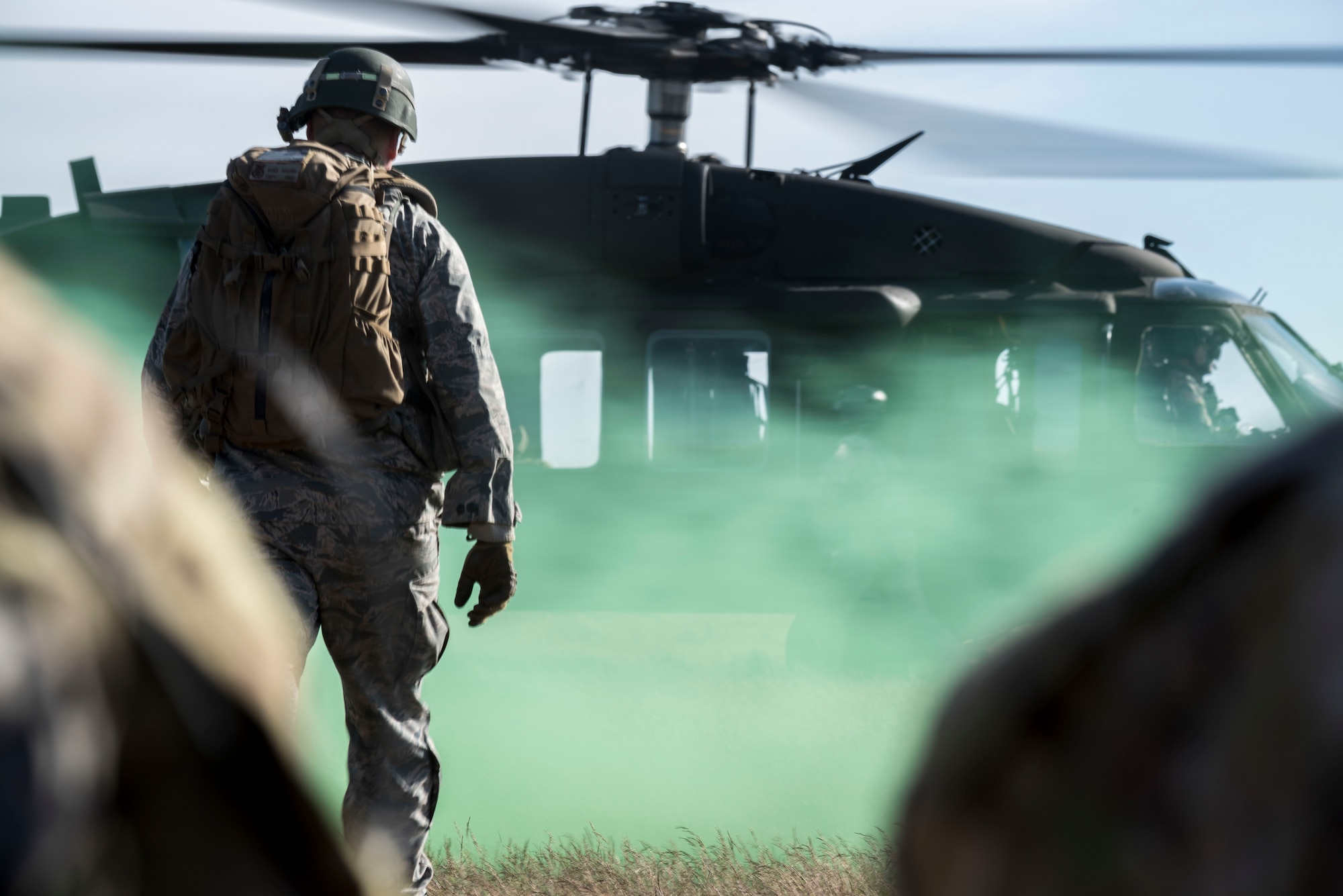 Capt. Ryan Kiggins, a 366th Security Forces Squadron operations officer, approaches an Army UH-60 Blackhawk during Gunfighter Flag 15-2 at Saylor Creek Range, Idaho, April 15, 2015. Kiggins led members of the 366th SFS through a variety of scenarios to better prepare them for deploying to hostile locations. (U.S. Air Force photo/Airman 1st Class Jeremy L. Mosier)