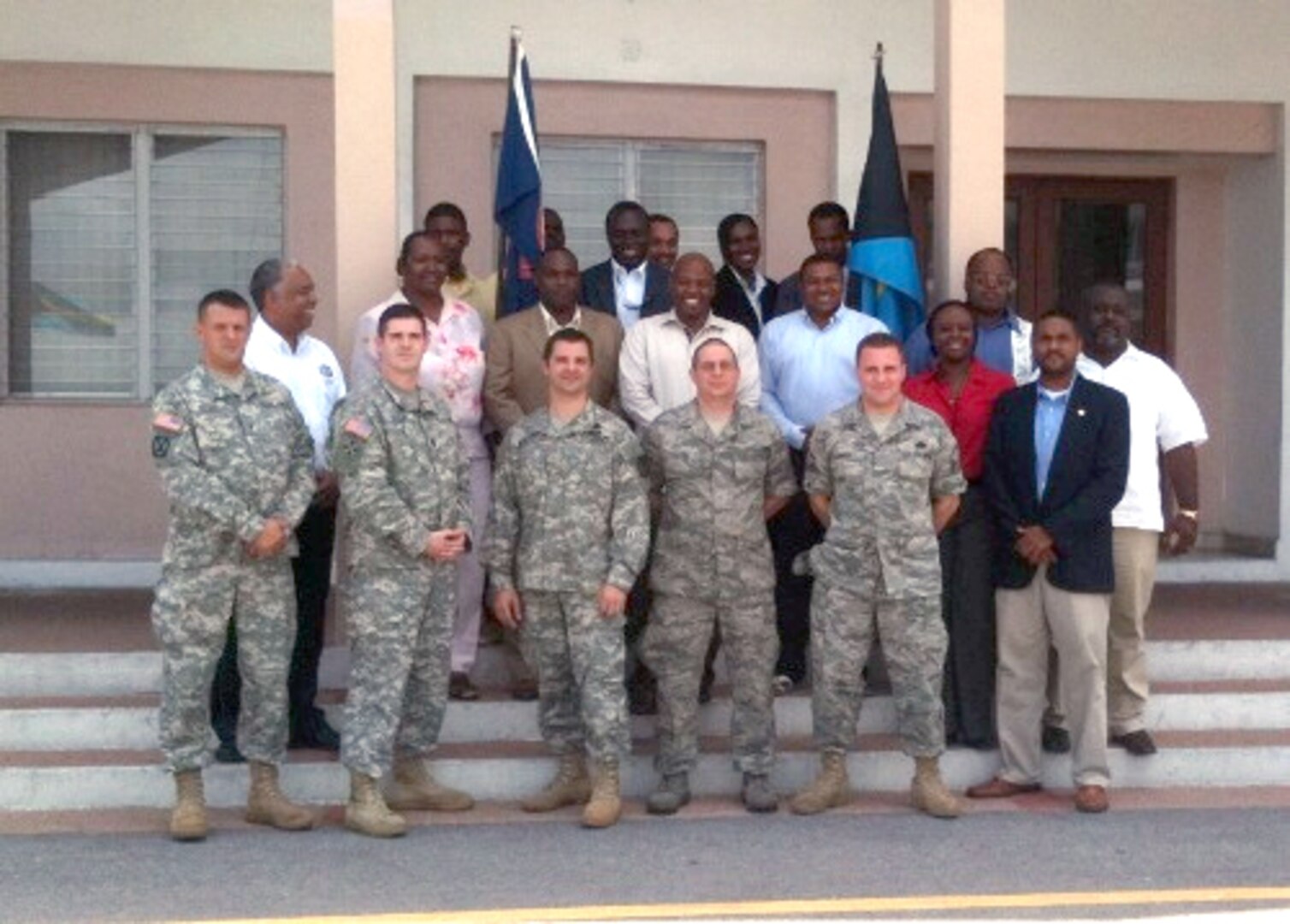 Rhode Island National Guard workshop facilitators from left to right, Chief Warrant Officer 3 Paul Pion, Capt. Jeff Lessard, Maj. Alan White, Master Sgt. Stephen Chasse and Master Sgt. Mark Larsen, pose for a photo with participants from the Royal Bahamas Police and Defense Forces.