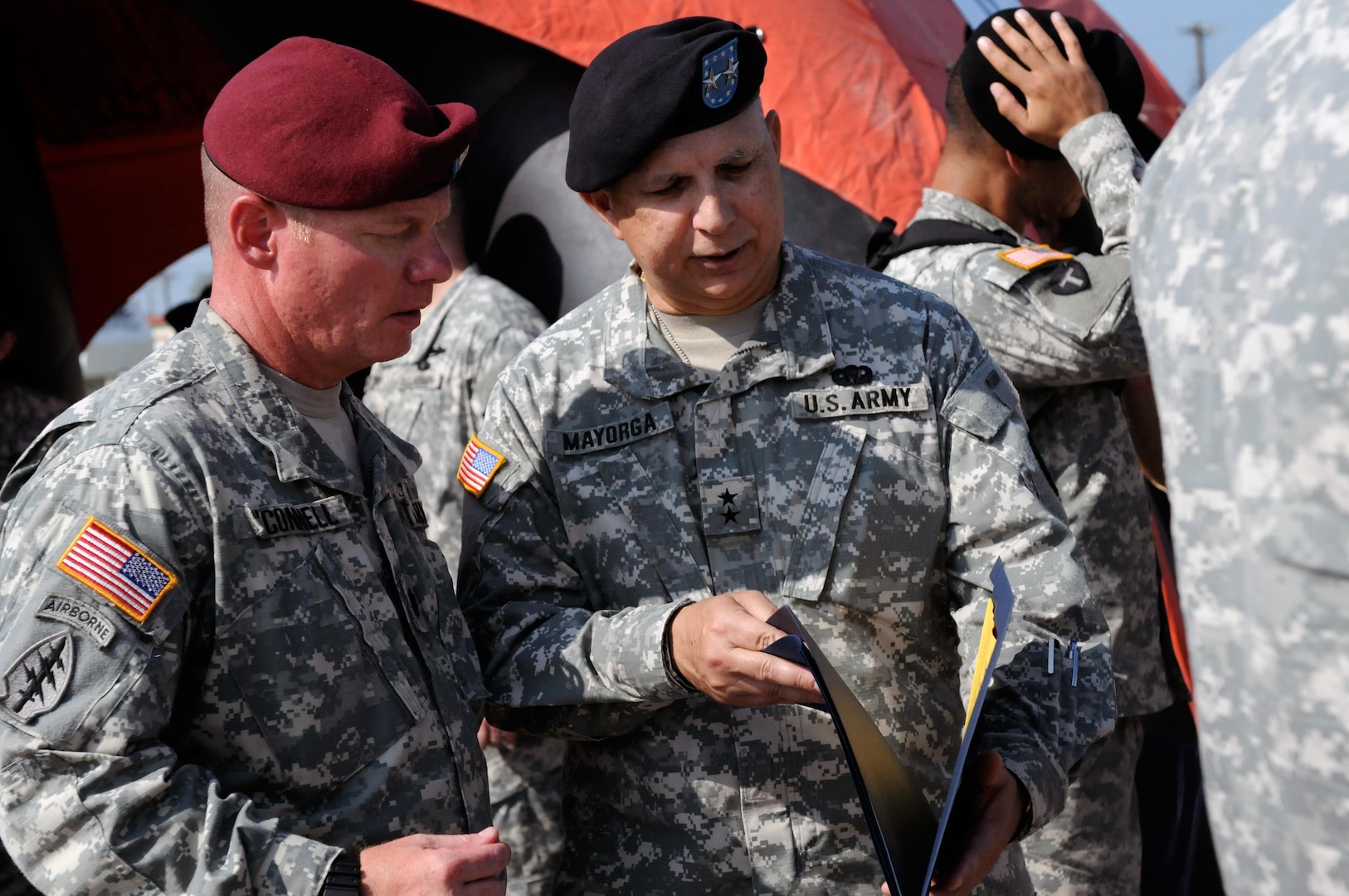 Lt. Col. Douglas of O'Connell, commander of 1st Battalion of the 143rd Infantry Regiment (Airborne), talks with Maj. Gen. Jose S. Mayorga, the adjutant general of the Texas National Guard, after the reactivation ceremony of the 1st Battalion of the 143rd Infantry Regiment (Airborne) at the Texas State Technical College airport in Waco, Texas, Sept. 11, 2010.