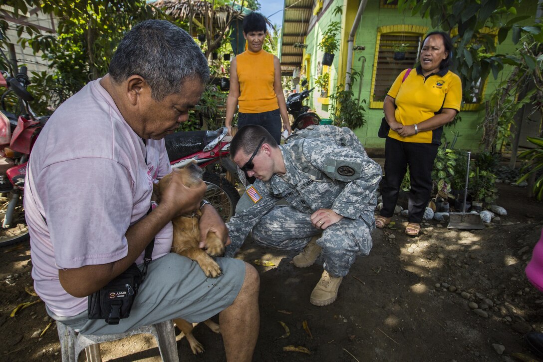 U.S. Army Capt. Andrew Armstrong, veterinarian, Public Health District Japan, gives a dog a dose of rabies vaccination in Puerto Princesa, Philippines, during exercise Balikatan 2015, April 18. The Armed Forces of the Philippines and U.S. Armed Forces conducted the vaccinations to prevent the spread of rabies and raise the overall health of animals in the area. This year marks the 31st iteration of the annual Philippine-U.S. bilateral training exercise and humanitarian civic assistance engagement.