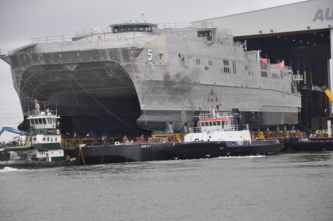 The future Military Sealift Command joint high-speed vessel USNS Trenton (JHSV 5) rolls out in preparation for launch at Austal USA shipyard.