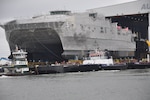 The future Military Sealift Command joint high-speed vessel USNS Trenton (JHSV 5) rolls out in preparation for launch at Austal USA shipyard.