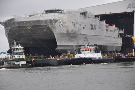 The future Military Sealift Command joint high-speed vessel USNS Trenton (JHSV 5) rolls out in preparation for launch at Austal USA shipyard.