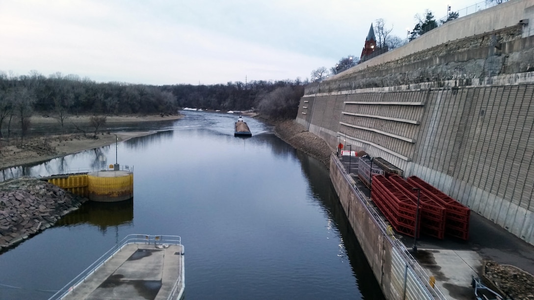 Early in the morning of April 2, 2015, Aggregate Industries' MV Patrick Gannaway pushes two barges loaded with sand and gravel into the lock chamber at Lock and Dam 1, located adjacent to Minnehaha Park in Minneapolis. 