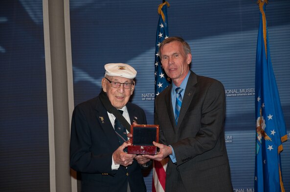 Doolittle Raider retired Lt. Col. Richard Cole presents the Raiders’ Congressional Gold Medal to retired Lt. Gen. John Hudson, the director of the National Museum of the U.S. Air Force, during a ceremony at Wright-Patterson Air Force Base, Ohio, April 18, 2015. The medal is on display in the museum’s World War II Gallery in the Doolittle Raid exhibit. (U.S. Air Force photo/Niki Jahns)