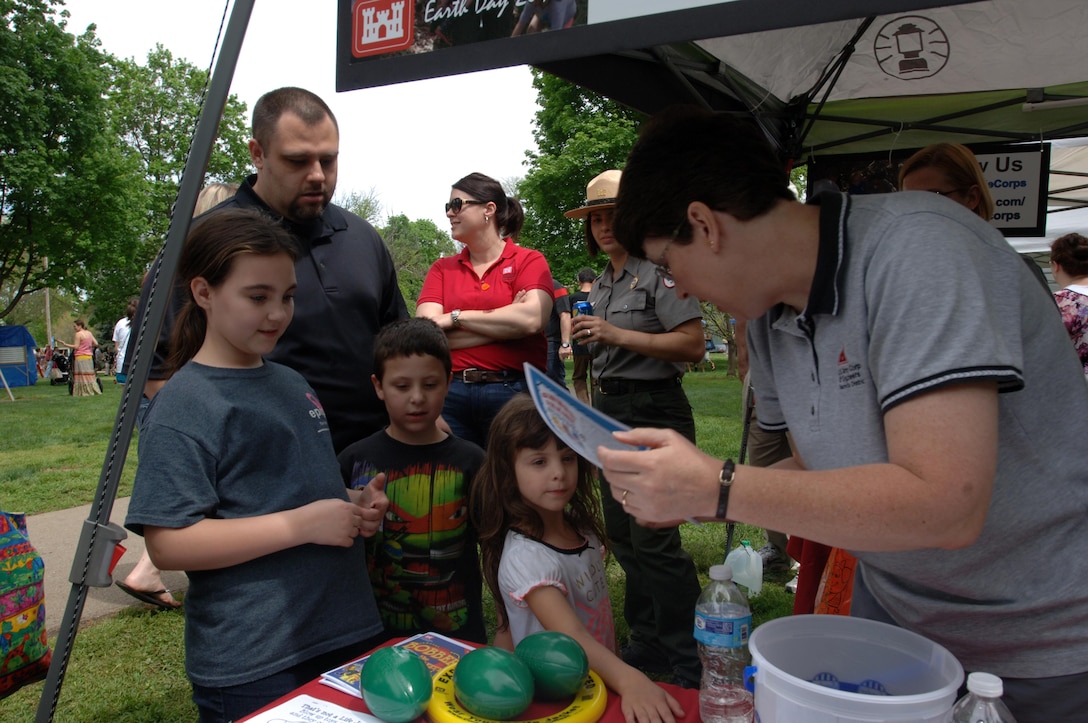 Biologist Kim Franklin (Right) hands out water safety coloring pages to kids during the Nashville Earth Day Festival April 18, 2015 at Centennial Park.  The U.S. Army Corps of Engineers Nashville District’s employees shared information with the public about environmental stewardship and water safety.