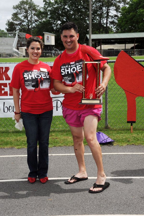 Sporting hot pink pants, Sgt. Greg Rieder, mechanic, Installation and Environment Division, showcases his best legs category trophy. Men from all walks of life, including Marines and Sailors stationed at Marine Corps Logistics Base Albany, volunteered to support the “Walk a Mile in Her Shoes” event benefitting Lily Pad, a local non-profit organization that supports victims of sexual assault and child abuse. The annual event was held April 18 at Deerfield-Windsor Upper Campus Track, Albany, Georgia.