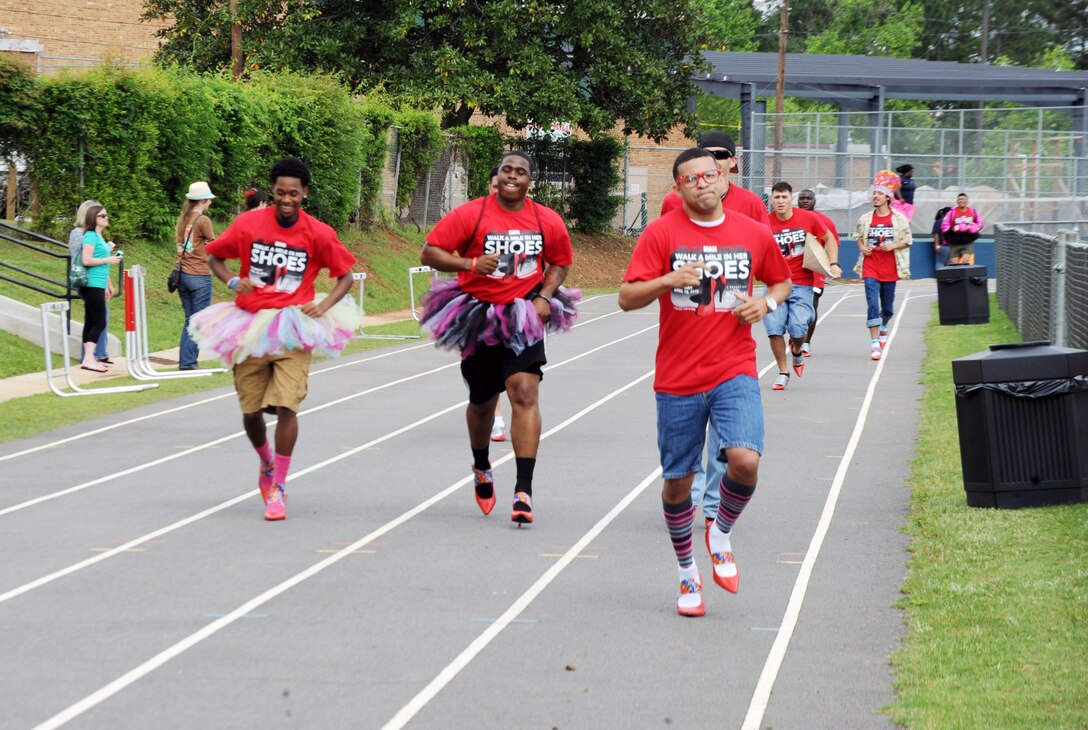 Dozens of men trade in their regular shoes for a pair of 3-inch high red pumps, all for a good cause, April 18, at Deerfield-Windsor Upper Campus Track, Albany, Georgia. Men from all walks of life, including Marines and Sailors stationed at Marine Corps Logistics Base Albany, volunteered to support the “Walk a Mile in Her Shoes” event benefitting Lily Pad, a local non-profit organization that supports victims of sexual assault and child abuse.
