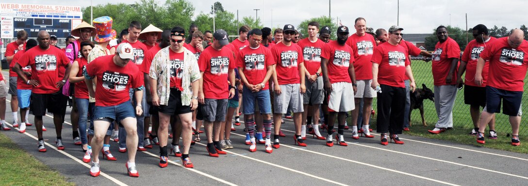 Dozens of men trade in their regular shoes for a pair of 3-inch high red pumps, all for a good cause, April 18 at Deerfield-Windsor Upper Campus Track, Albany, Georgia. Men from all walks of life, including Marines and Sailors stationed at Marine Corps Logistics Base Albany, volunteered to support the “Walk a Mile in Her Shoes” event benefitting Lily Pad, a local non-profit organization that supports victims of sexual assault and child abuse.

