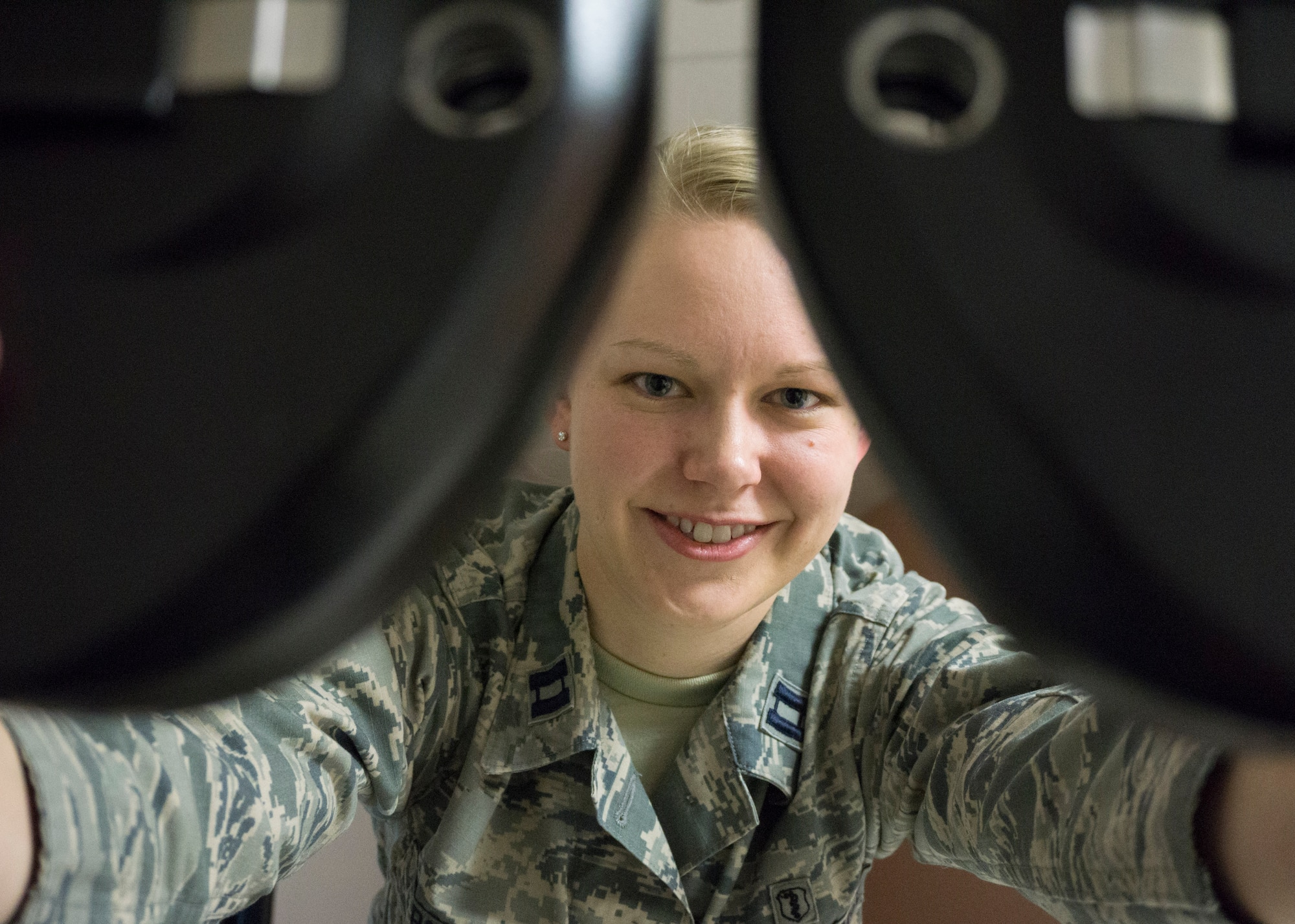 Capt. Paige Bosch, 90th Medical Operations Squadron optometrist, poses for a portrait in her office at the F.E. Warren Medical Treatment Facility, Wyo., April 16, 2015. Bosch is a new addition to the 90th MDOS. (U.S. Air Force photo by Lan Kim)
