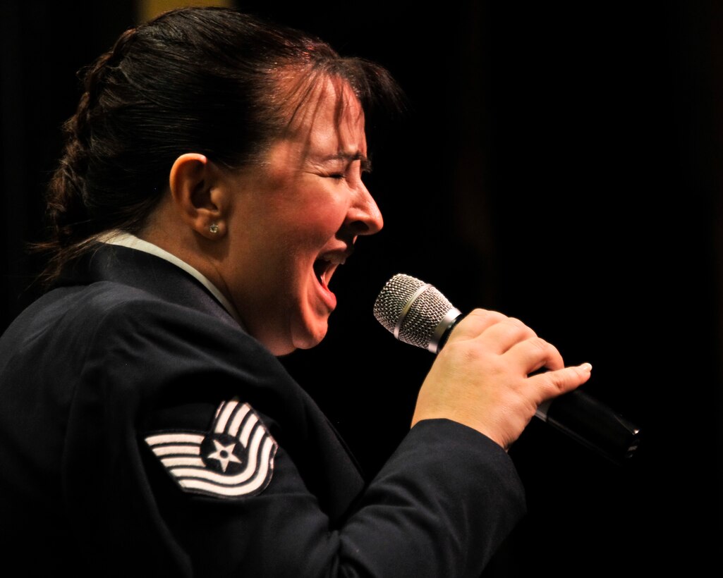 U.S. Air Force Tech. Sgt. Peggy K. Miller, an instrumentalist with the 566th Air Force Band, sings "Alright, OK, You Win" during a performance at the Illinois Music Educators Association conference opening night in Peoria, Ill., Jan. 28, 2015. The 566 AFB serves in war and peace by preserving national heritage through the power of music at military, recruiting and community relations events. (U.S. Air National Guard photo by Staff Sgt. Lealan Buehrer/Released)