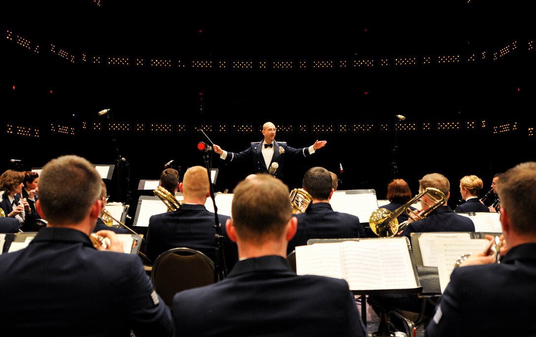 U.S. Air Force Maj. Bryan M. Miller, commander of the 566th Air Force Band, conducts the band during a performance at the Illinois Music Educators Association conference opening night in Peoria, Ill., Jan. 28, 2015. The 566 AFB serves in war and peace by preserving national heritage through the power of music at military, recruiting and community relations events. (U.S. Air National Guard photo by Staff Sgt. Lealan Buehrer/Released)