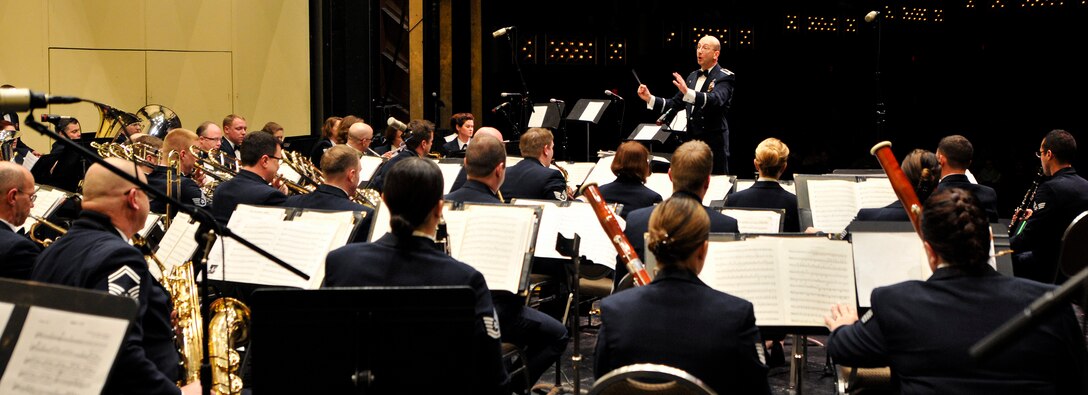 U.S. Air Force Maj. Bryan M. Miller, commander of the 566th Air Force Band, conducts the band during a performance at the Illinois Music Educators Association conference opening night in Peoria, Ill., Jan. 28, 2015. The 566 AFB serves in war and peace by preserving national heritage through the power of music at military, recruiting and community relations events. (U.S. Air National Guard photo by Staff Sgt. Lealan Buehrer/Released)