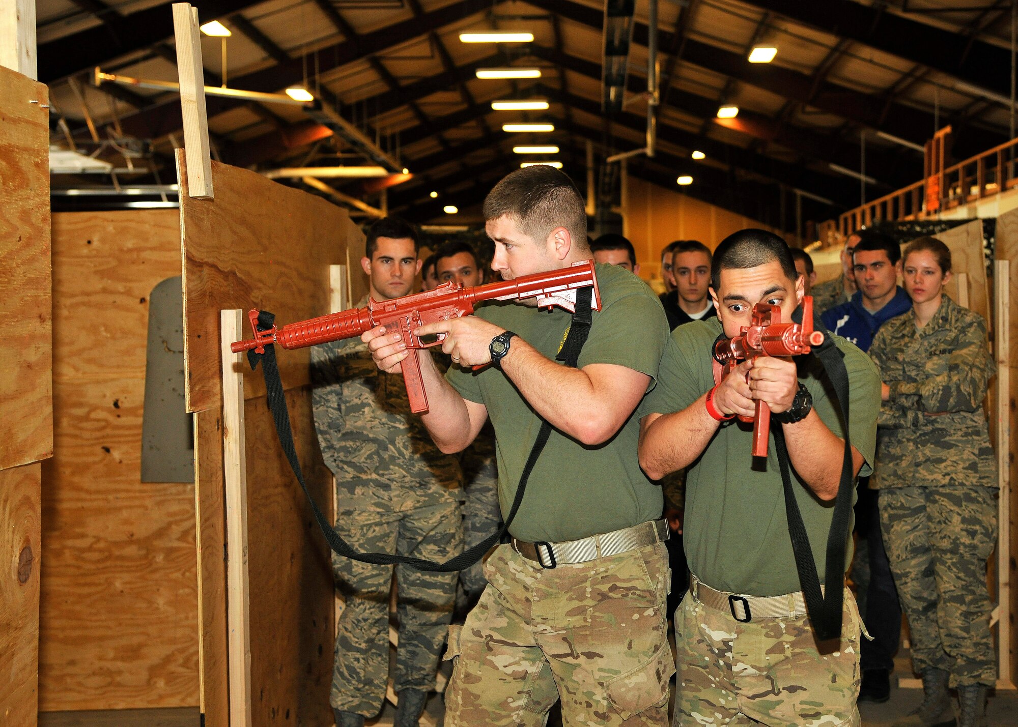 (left) Staff Sgt. Jonathan Hogg, 319th Security Forces Squadron NCO-in-charge of training and (right) Senior Airman Oscar Gomez-Villatoro, 319th Security Forces Squadron NCOIC of confinement, demonstrate on how to properly clear a building during a field training exercise Apr. 18, 2015, on Grand Forks Air Force Base, N.D. Cadets from the Air Force Reserve Officers’ Training Corps at the University of North Dakota Detachment 610 were taught how to perform small team tactics. (U.S. Air Force photo by Senior Airman Xavier Navarro/Released) 