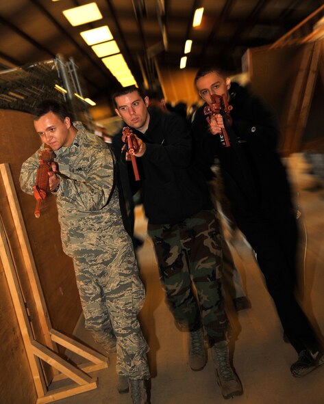 Cadets from the Air Force Reserve Officers’ Training Corps at the University of North Dakota Detachment 610 perform a building clearing procedure during a training exercise Apr. 18, 2015, on Grand Forks Air Force Base, N.D. Cadets were shown different techniques on how to clear rooms and enter rooms while keeping a tight formation. (U.S. Air Force photo by Senior Airman Xavier Navarro/Released)