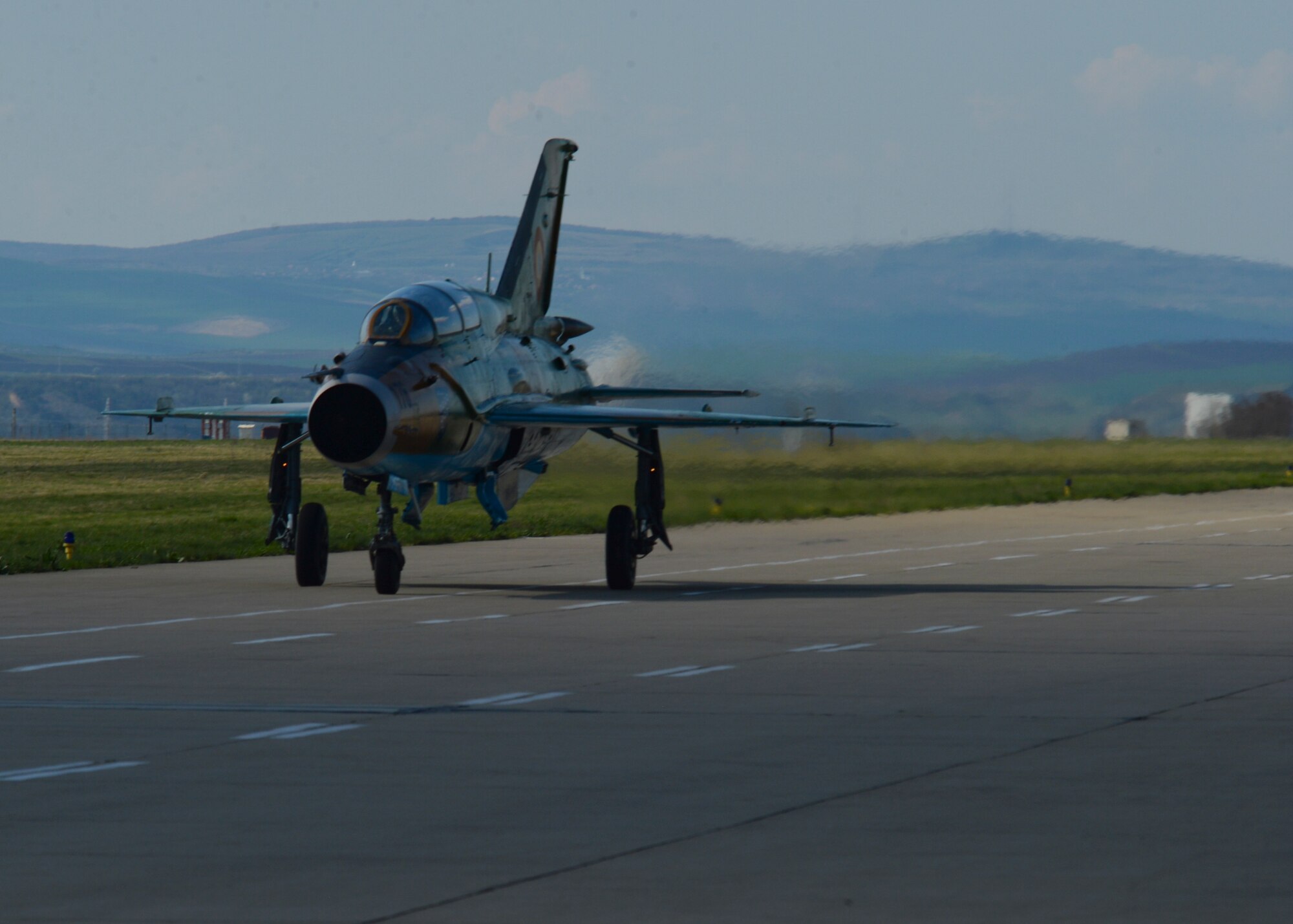 A Romanian air force MiG-21 fighter aircraft assigned to the 71st Air Base taxies on the flightline at Campia Turzii, Romania, April 16, 2015. The U.S. and Romanian air forces will conduct training aimed to strengthen interoperability and demonstrate the countries' shared commitment to the security and stability of Europe. (U.S. Air Force photo by Staff Sgt. Joe W. McFadden/Released)
