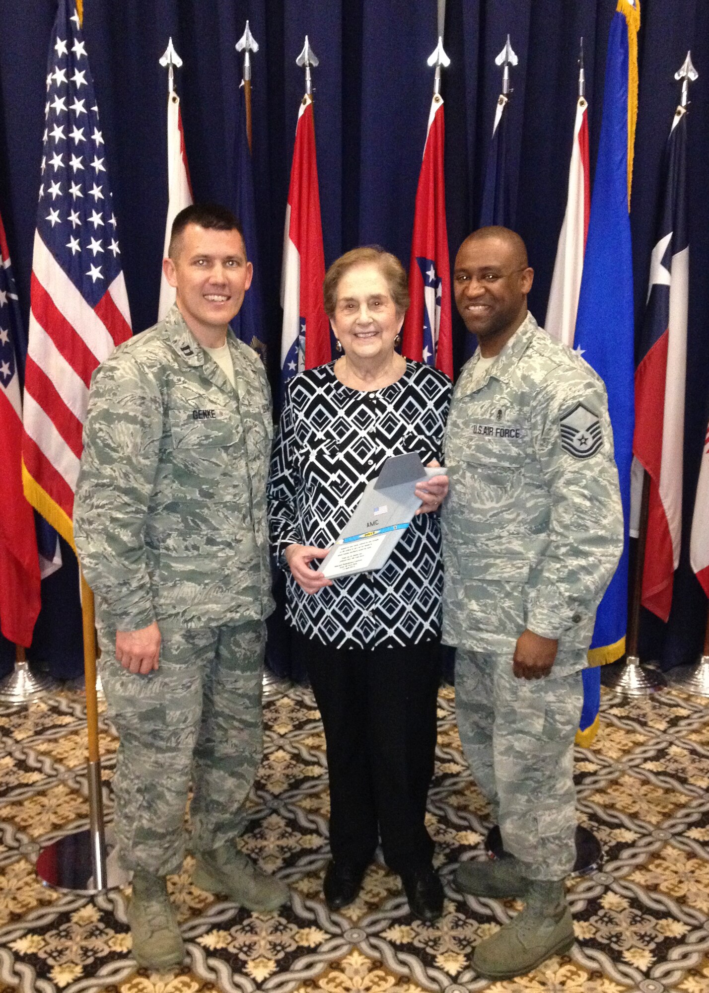 Chaplain (Capt.) Quentin Genke, 436th Airlift Wing chaplain, and Master Sgt. Richard Matthews, Jr., 436th Medical Operations Squadron Mental Health flight chief, pose for a photo with Ann Jaffe April 14, 2015, at the Landings on Dover Air Force Base, Del. Jaffe is a Holocaust survivor and was the guest speaker of the 2015 National Holocaust Remembrance Luncheon. (Courtesy photo)