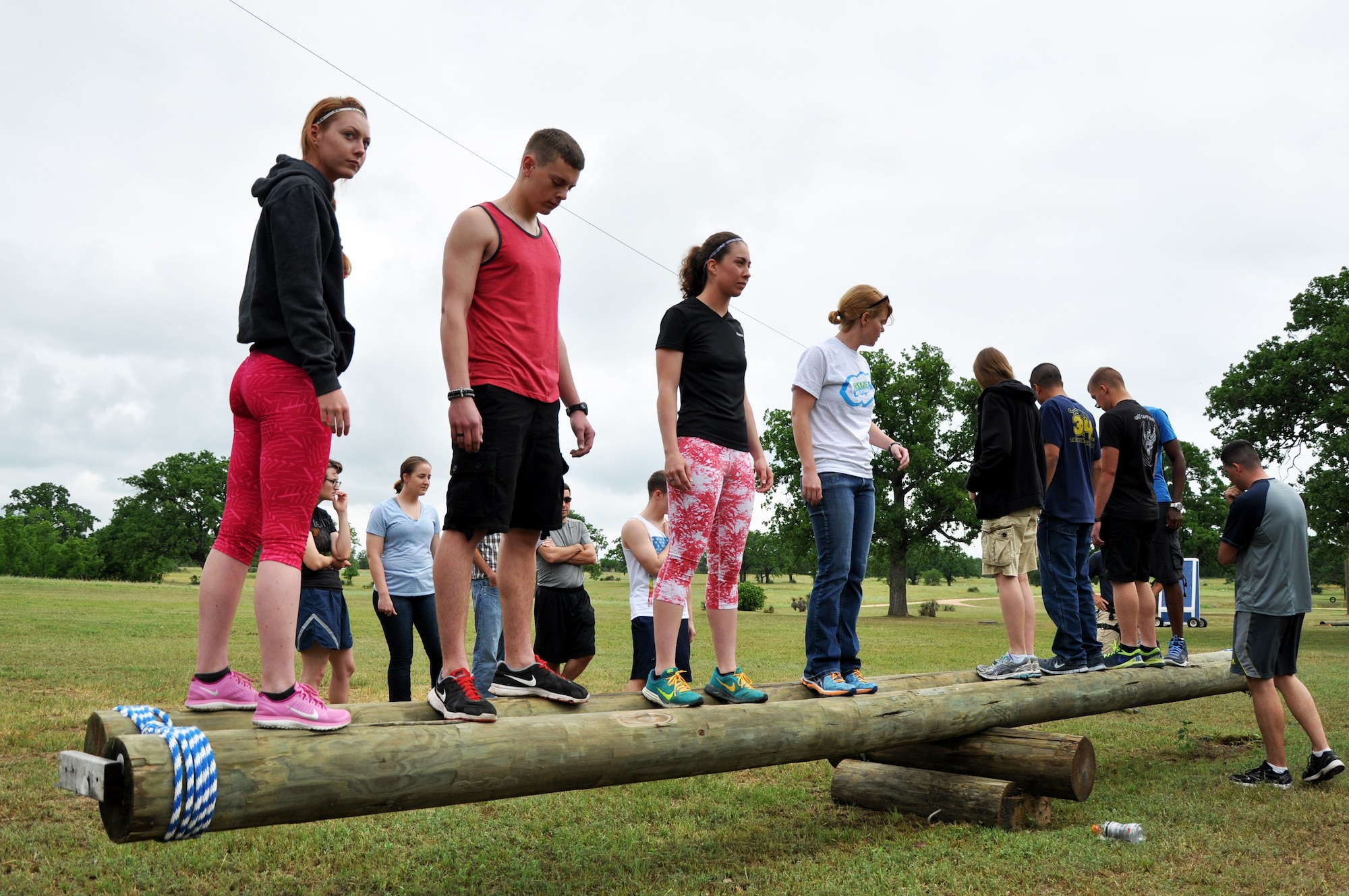 BURNET, Texas – Individuals work together to balance a teetering log at the Lone Star Peak Performance course April 18. The course facilitators made the group participate in this exercise to help build teamwork skills. (U.S. Air Force photo/ Senior Airman Joshua Edwards)