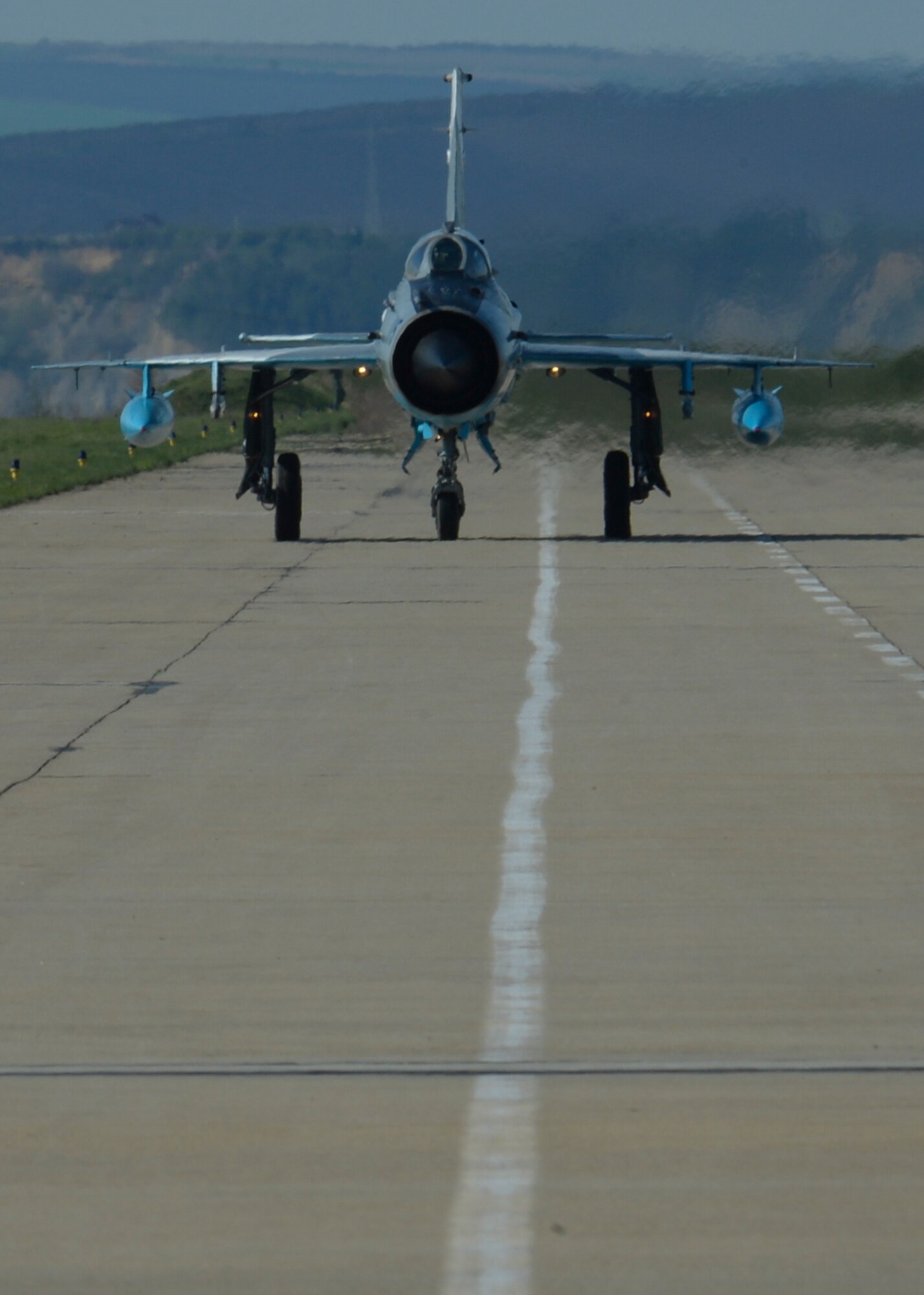 A Romanian air force MiG-21 fighter aircraft assigned to the 71st Air Base taxies on the flightline at Campia Turzii, Romania, April 16, 2015. The U.S. and Romanian air forces will conduct training aimed to strengthen interoperability and demonstrate the countries' shared commitment to the security and stability of Europe. (U.S. Air Force photo by Staff Sgt. Joe W. McFadden/Released)