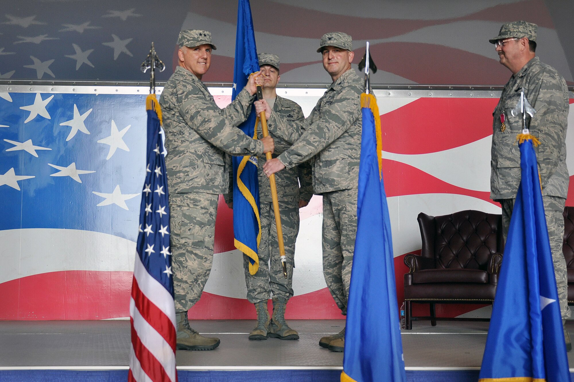 After taking the flag from Col Gregory Gilmour, Maj Gen John Flournoy presents the guidon to Col Craig Shenkenberg, Commander of the 916th Air Refueling Wing at the Change of Command Ceremony at 0916 hours on April 18, 2015.