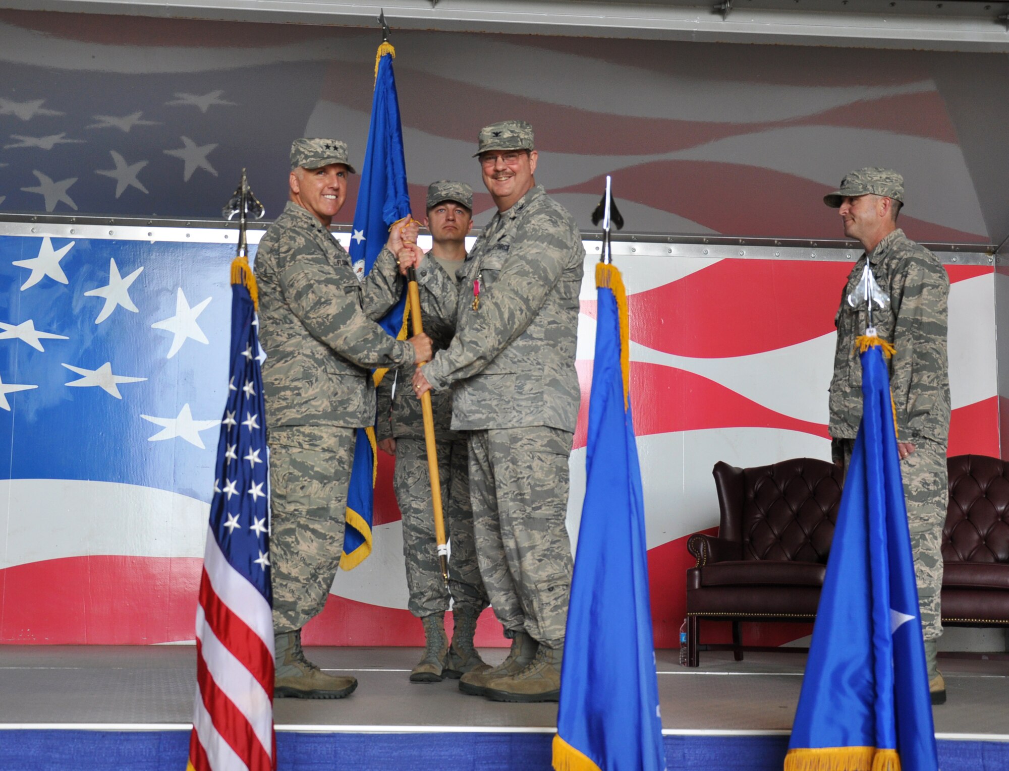 Departing Commander Col Gregory Gilmour, after taking the flag from Chief Loper, presents it to Maj Gen Flournoy relinquishing command of the 916th Air Refueling Wing back the the 4th AF Commander at the Change of Command Ceremony at 0916 hours on April 18, 2015.