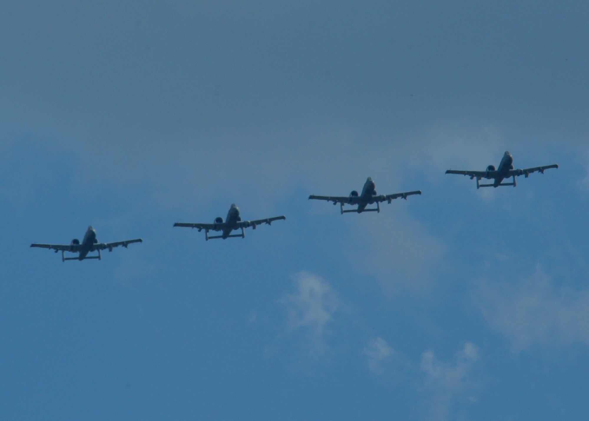 Four U.S. Air Force A-10 Thunderbolt II aircraft assigned to the 354th Expeditionary Fighter Squadron fly above the flightline at Campia Turzii, Romania, April 16, 2015. The U.S. and Romanian air forces will conduct training aimed to strengthen interoperability and demonstrate the countries' shared commitment to the security and stability of Europe. (U.S. Air Force photo by Staff Sgt. Joe W. McFadden/Released)