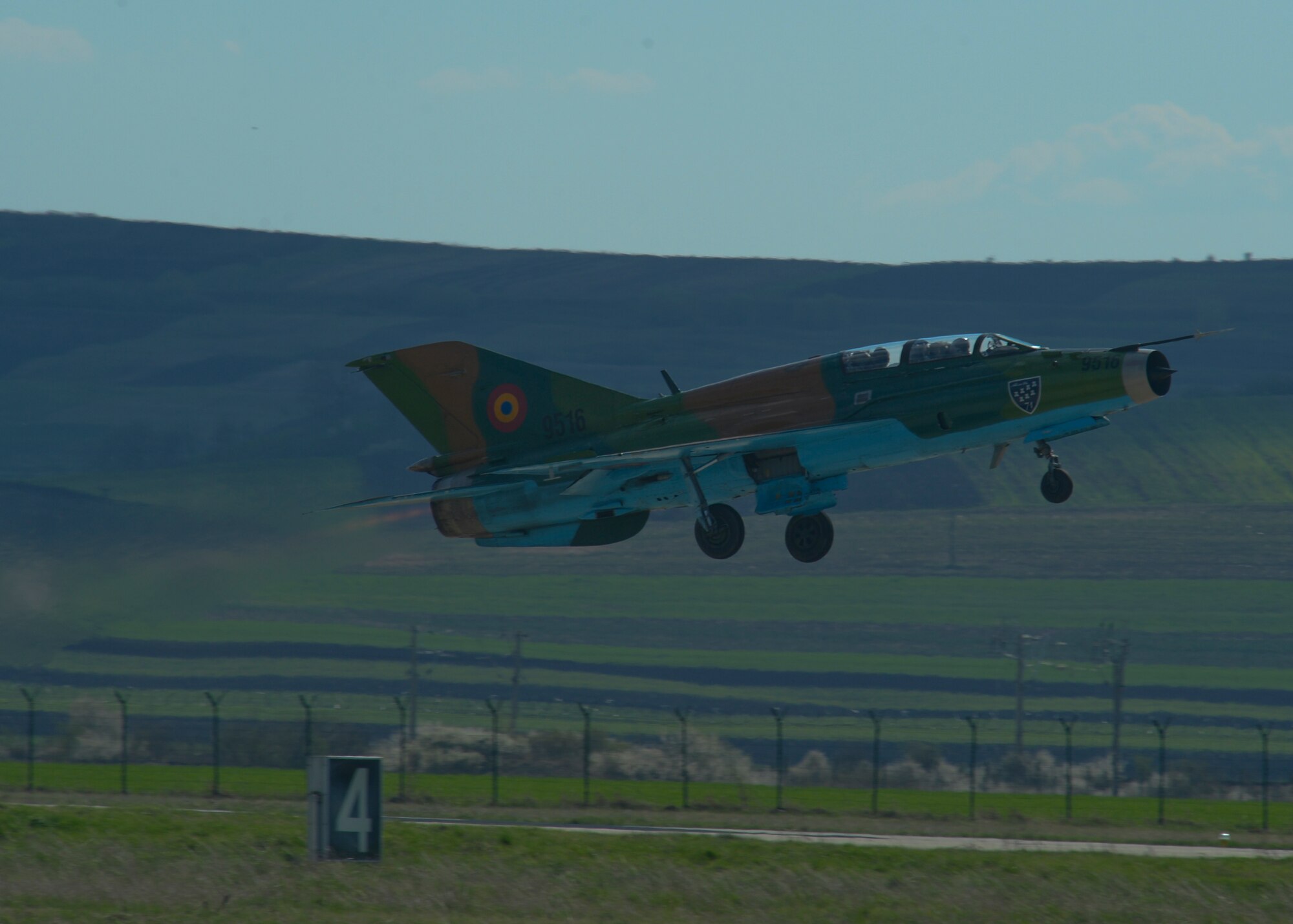 A Romanian air force MiG-21 fighter aircraft assigned to the 71st Air Base takes off from the flightline at Campia Turzii, Romania, April 16, 2015. The U.S. and Romanian air forces will conduct training aimed to strengthen interoperability and demonstrate the countries' shared commitment to the security and stability of Europe. (U.S. Air Force photo by Staff Sgt. Joe W. McFadden/Released)