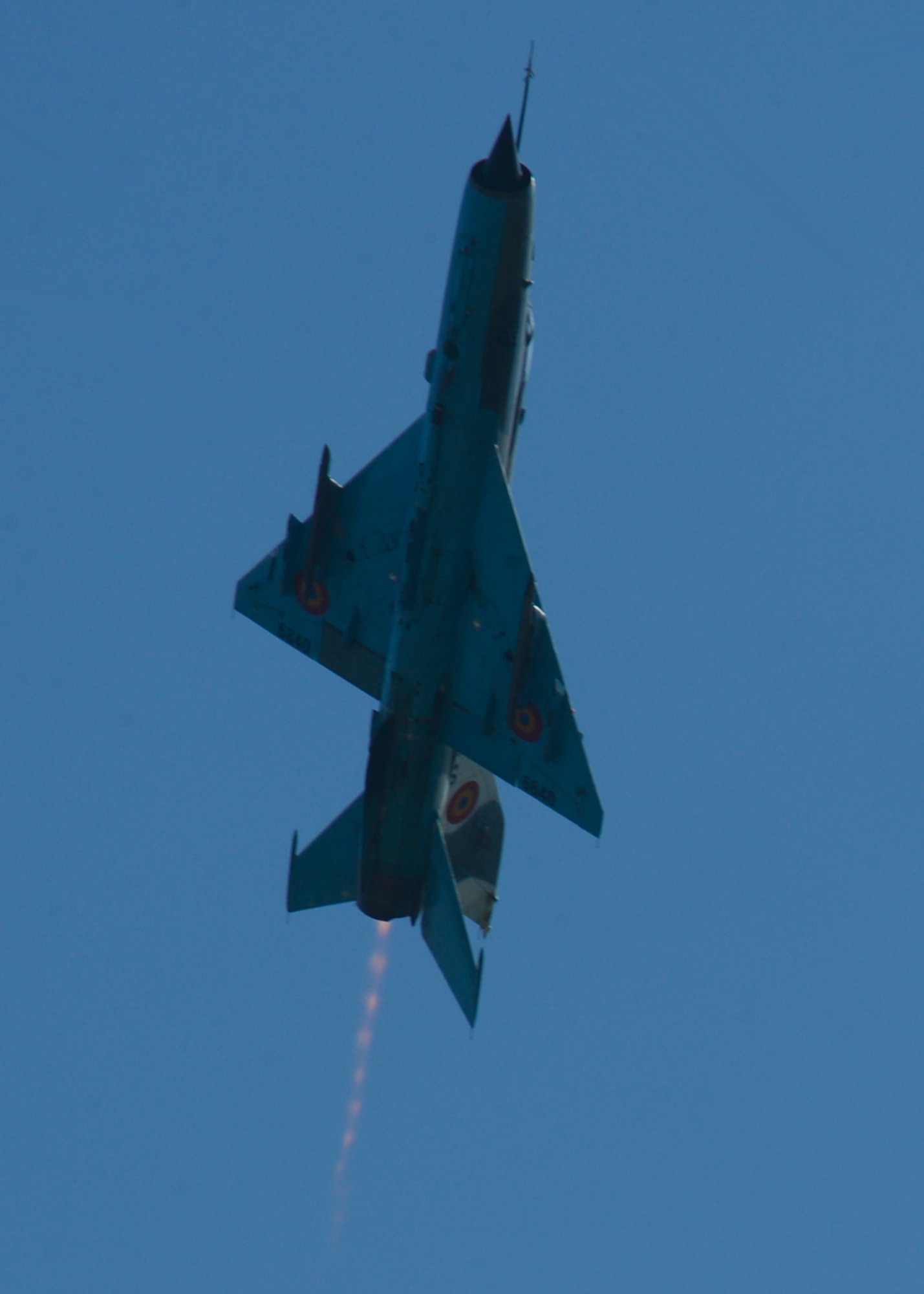 A Romanian air force MiG-21 fighter aircraft assigned to the 71st Air Base flies above the flightline at Campia Turzii, Romania, April 16, 2015. The U.S. and Romanian air forces will conduct training aimed to strengthen interoperability and demonstrate the countries' shared commitment to the security and stability of Europe. (U.S. Air Force photo by Staff Sgt. Joe W. McFadden/Released)