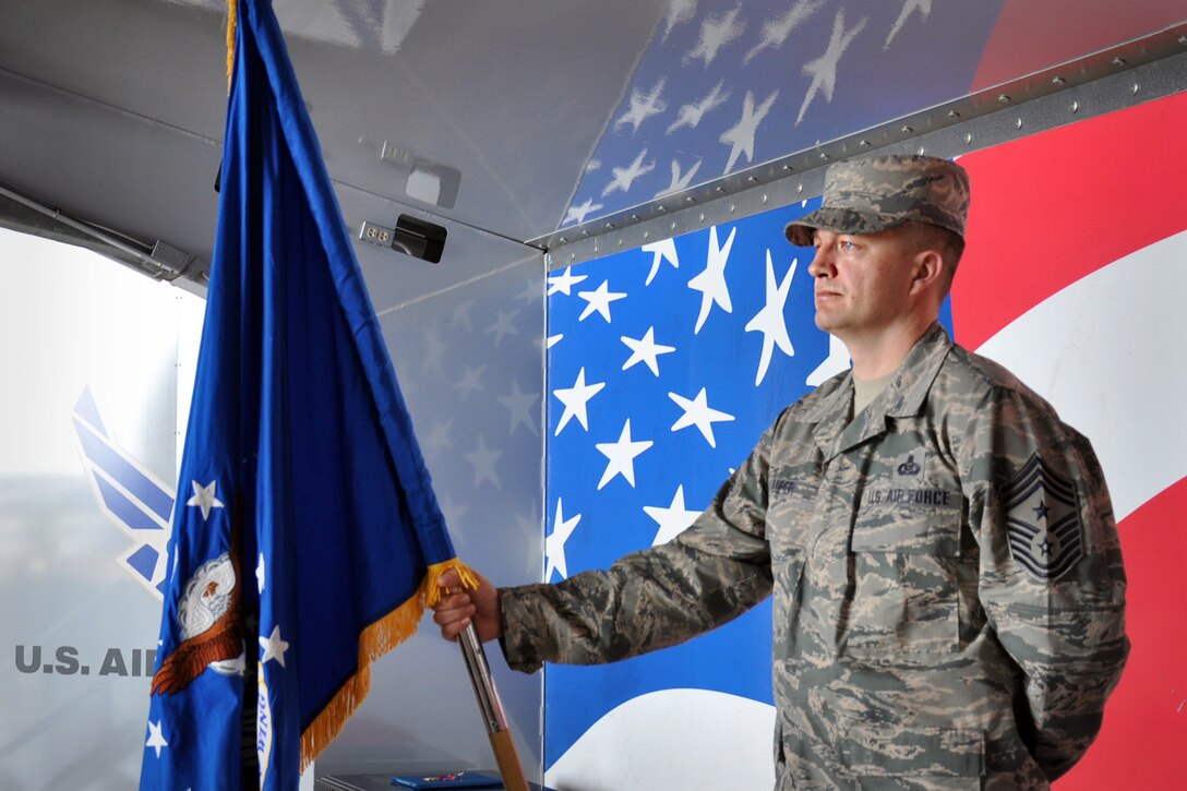 Command Chief Master Sergeant James W. Loper bears the guidon prior to the 916th Air Refueling Wing Change of Command Ceremony at 0916 hours on April 18, 2015.