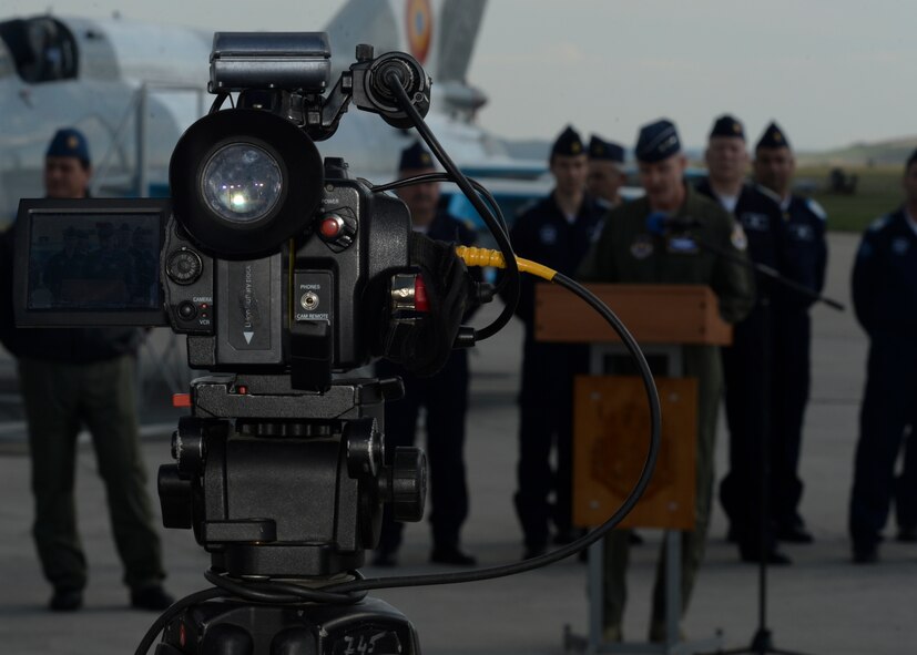 A video camera belonging to a Romanian news agency records U.S. Air Force Lt. Gen. Darryl Roberson, 3rd Air Force and 17th Expeditionary Air Force commander, as he speaks during a media event on the flightline at Campia Turzii, Romania, April 16, 2015. The event highlighted the accomplishments made between the U.S. Air Force's 354th Expeditionary Fighter Squadron and the Romanian air force's 71st Air Base in relation to Operation Atlantic Resolve, which aims to strengthen interoperability and demonstrate the countries' shared commitment to the security and stability of Europe. (U.S. Air Force photo by Staff Sgt. Joe W. McFadden/Released)