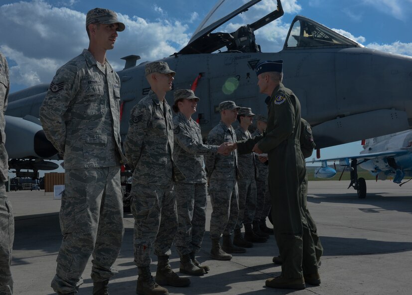 U.S. Air Force Lt. Gen. Darryl Roberson, 3rd Air Force and 17th Expeditionary Air Force commander, right, shakes the hand of a U.S. Air Force staff sergeant assigned to the 354th Expeditionary Fighter Squadron during the general's visit to Campia Turzii, Romania, April 16, 2015. The general congratulated the NCO for superior performance in her duties related to Operation Atlantic Resolve while stationed at Campia Turzii. (U.S. Air Force photo by Staff Sgt. Joe W. McFadden/Released)
