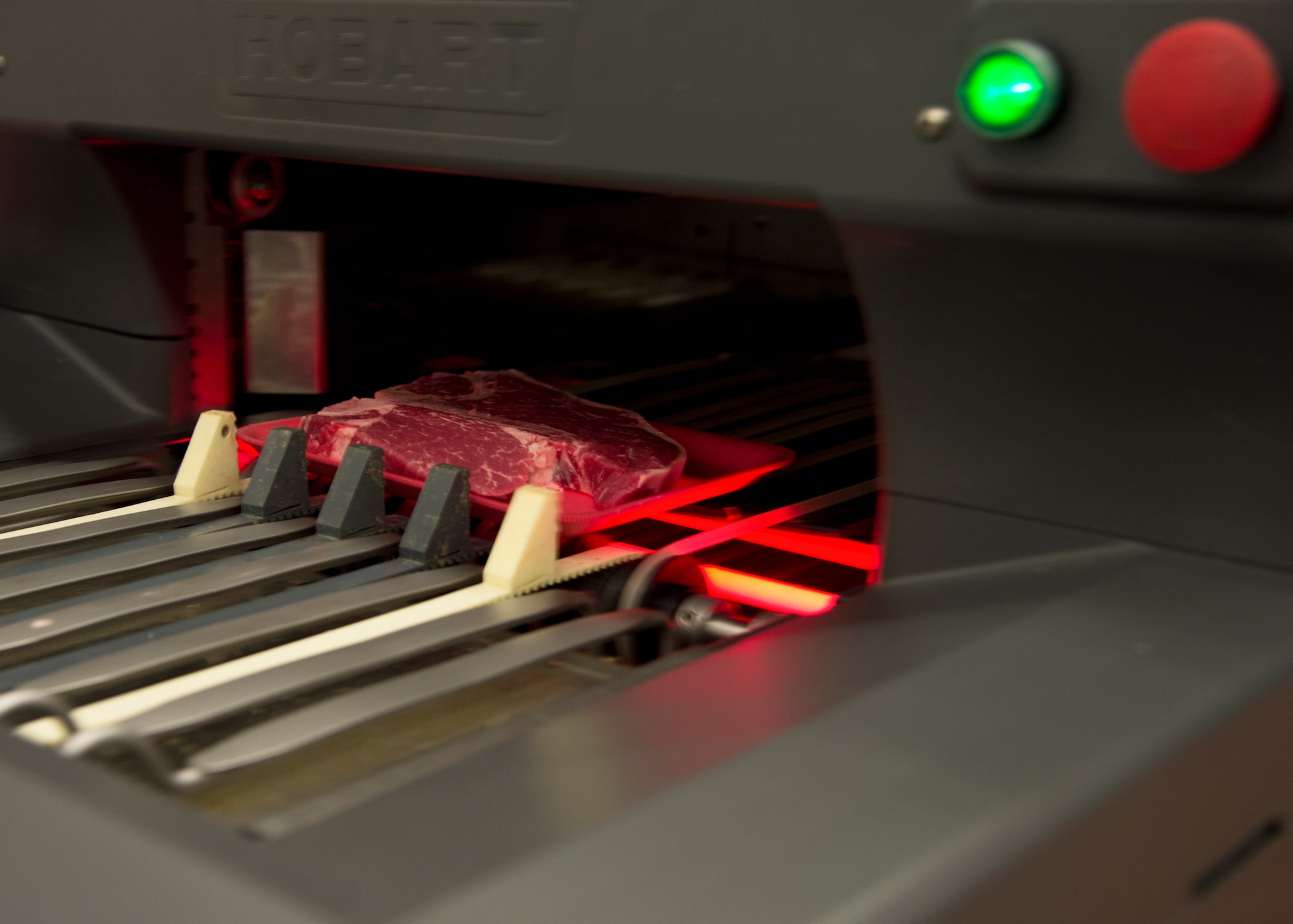 A single T-bone steak is sent through a Hobart wrapping machine April 17, 2015, at the Commissary on Dover Air Force Base, Del. The Commissary meat department offers single servings of steak, pork and chicken for Airmen who are shopping for individual servings. (U.S. Air Force photo/Airman 1st Class William Johnson)