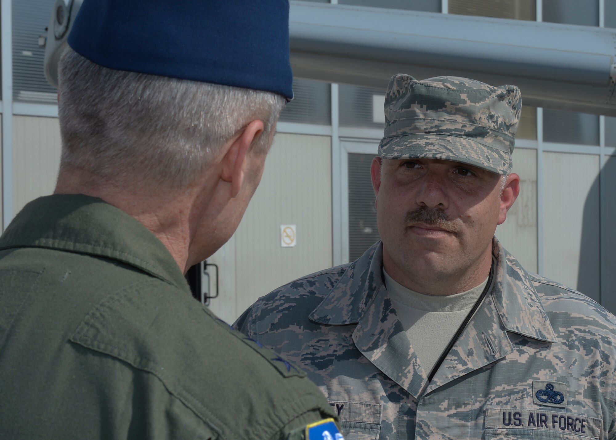 U.S. Air Force Lt. Gen. Darryl Roberson, 3rd Air Force and 17th Expeditionary Air Force commander, left, speaks with a U.S. Air Force senior NCO assigned to the 354th Expeditionary Fighter Squadron on the flightline at Campia Turzii, Romania, April 16, 2015. The general congratulated the senior NCO for superior performance in his duties related to Operation Atlantic Resolve while stationed at Campia Turzii. (U.S. Air Force photo by Staff Sgt. Joe W. McFadden/Released)